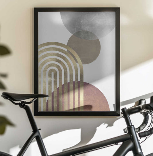 Composition lines and circles 2 by Vitor Costa, black-framed artwork above a bicycle; nested gold-toned arches overlapping gray, taupe and muted terracotta circles.