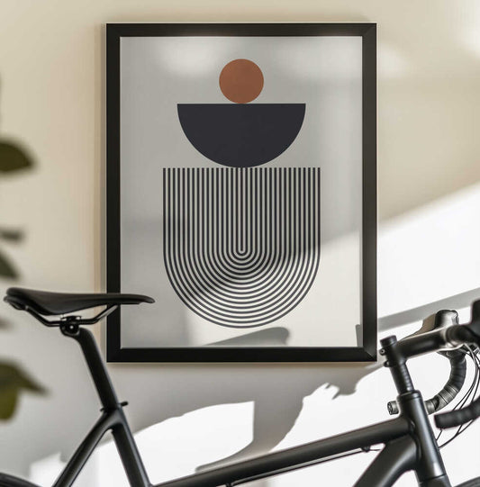 Geometric Shapes with a Black Semicircle by Vitor Costa, black-framed artwork above a bicycle; an orange circle above a black semicircle and fine nested U-shaped lines.