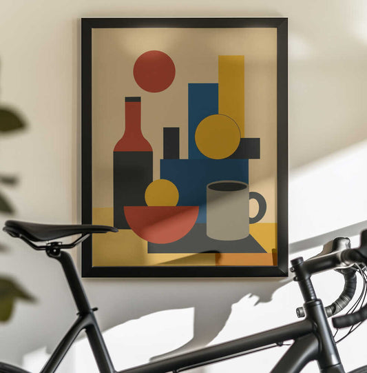 Geometric Still Life with Bottle 02 by Little Dean: black-framed art above a bicycle, showing a red-and-black bottle, red bowl and gray mug among blue and yellow geometric shapes.