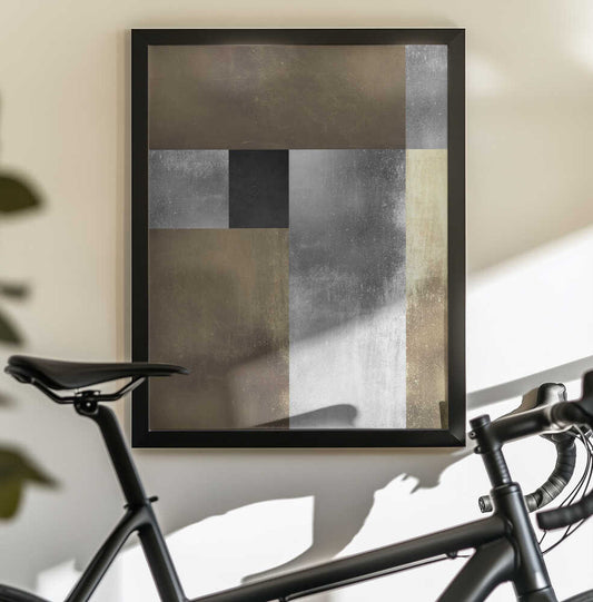 Gold and silver textures 1 by Vitor Costa, black-framed artwork above a bicycle; broad gold-toned and silver-gray rectangles with a small dark central block.