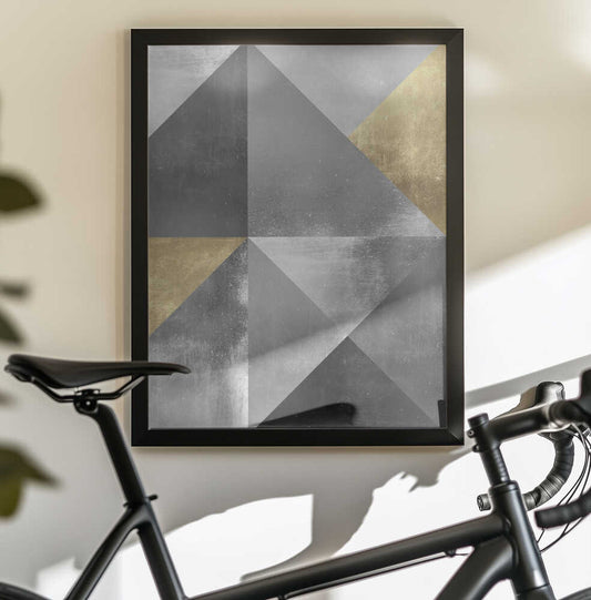 Gold and silver textures 2 by Vitor Costa, black-framed artwork above a bicycle; angular gray triangles and gold-toned facets meeting at sharp geometric edges.
