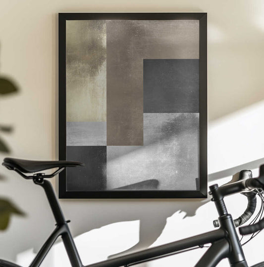 Gold and silver textures 4 by Vitor Costa, black-framed artwork above a bicycle; stepped gray and gold-toned rectangular planes forming an angular abstract structure.