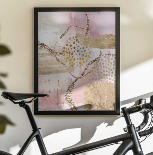 Golden Sunrise-2 by Sally Ann Moss, black-framed artwork above a bicycle; pale pink abstraction with looping gold-toned lines and dots.