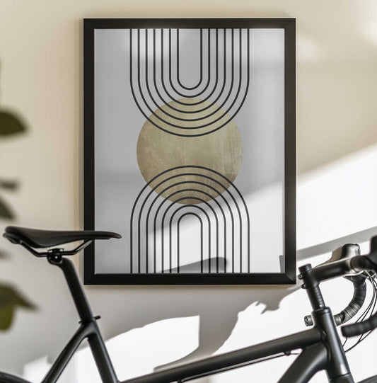 Golden Textured Circle and Bold Black Lines by Vitor Costa, black-framed artwork above a bicycle; a gold-toned disc between opposing open-ended nested black arches.