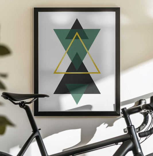 Minimal Triangle Collection #3 by jay stanley, black-framed artwork above a bicycle; stacked green and black triangles with a central yellow outline.