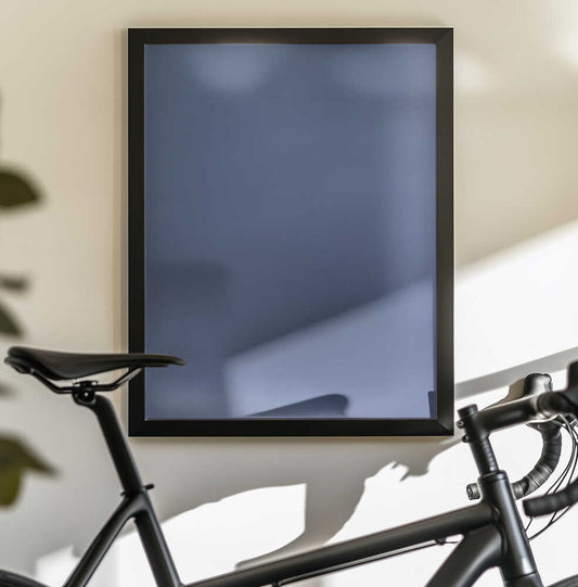 Never Stirred From Here by Mark Russell Jones — black-framed canvas displayed behind a bicycle