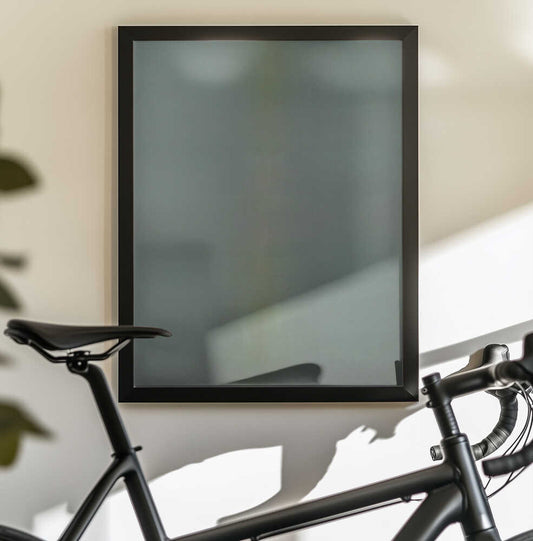 Ordered Rise by Mark Russell Jones — black-framed canvas displayed behind a bicycle