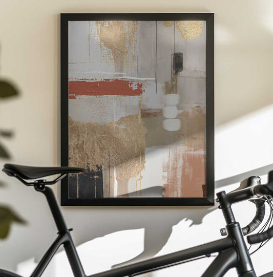 Terracotta Chaos 2 by Sally Ann Moss, black-framed artwork above a bicycle; gold-toned abstract layers with a terracotta horizontal stroke.