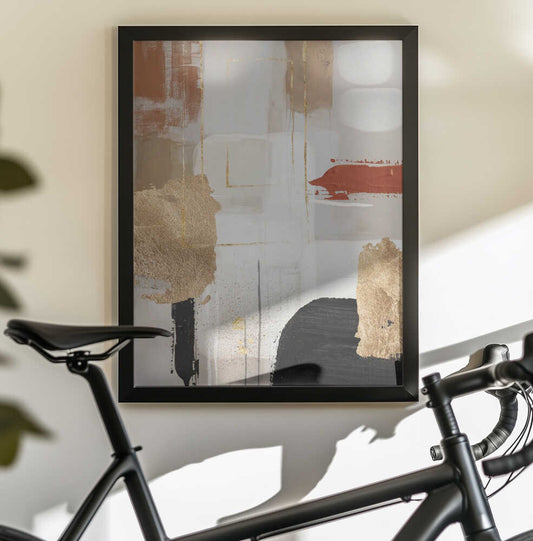 Terracotta Chaos 3 by Sally Ann Moss, black-framed artwork above a bicycle; cream and gold-toned abstraction with terracotta and black.