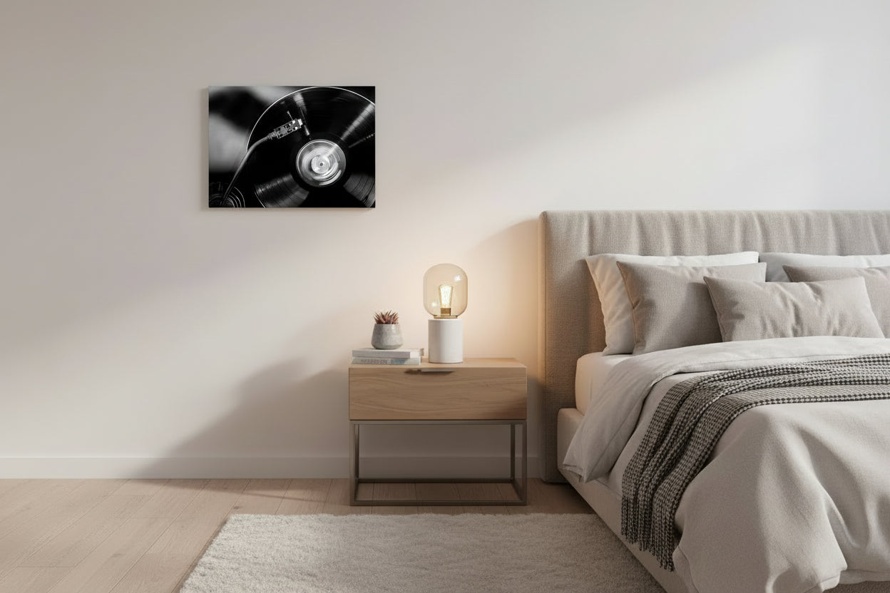 Canvas print hang on the right side of the bed . Setting in a warm minimal aesthetic .  