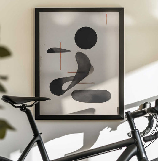 Abstract Flowforms by THE MIUUS STUDIO, black-framed artwork above a bicycle; rounded black shapes and a curved gray ribbon with fine warm linear accents.