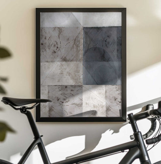Abstract Geometric Pattern by cartissi, black-framed artwork above a bicycle; overlapping gray and charcoal rectangles and triangular planes with weathered-looking surfaces.