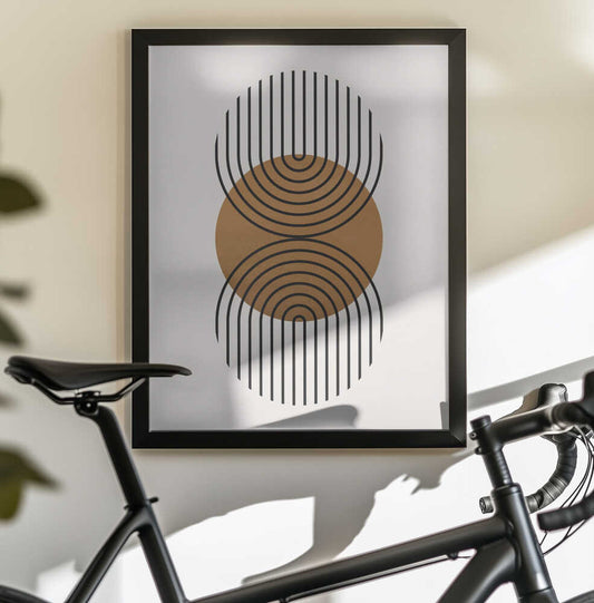 Art with circles 1 by Vitor Costa, black-framed artwork above a bicycle; an ochre circle between opposing sets of nested black curved lines.
