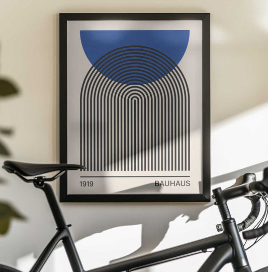 Bauhaus art 4 by Vitor Costa, black-framed artwork above a bicycle; a blue semicircle overlapping nested black arches above Bauhaus lettering.