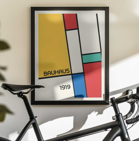 Bauhaus Geometric Design Retro by Retrodrome, black-framed artwork above a bicycle; yellow, red and blue geometric blocks with Bauhaus 1919 text.
