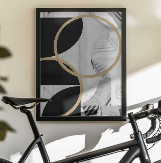Black and White Stripes Gold Spheres No1 by cartissi, black-framed artwork above a bicycle; large gold-toned rings over black shapes and gray stripes.