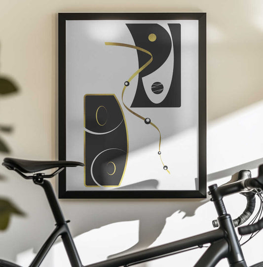 Black & White Abstract No. 2 | gold by Melanie Viola, black-framed artwork above a bicycle; black abstract shapes with looping gold-toned lines.