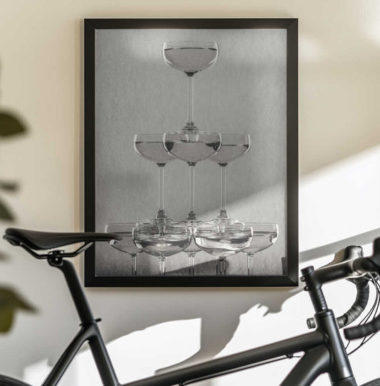 Champagne tower_9 by Pictufy Studio III — black-framed canvas displayed behind a bicycle
