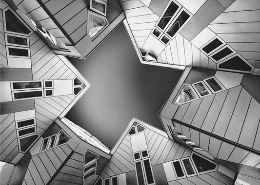 Cubic houses by Henk Langerak, front view of the artwork; angular house facades framing a star-shaped opening of sky.