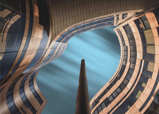 #D05 by Adam Pachula, front view of the artwork; curving architectural facades framing a patch of blue sky.
