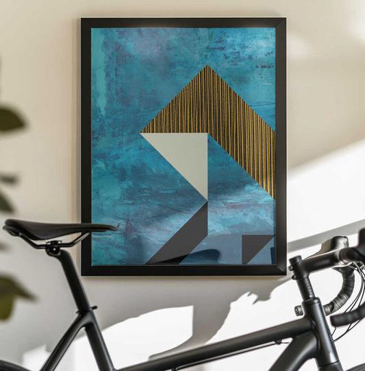 Dynamic Geometric Pattern by Petr Strnad, black-framed artwork above a bicycle; an angular gold-striped form and cream triangle against a textured turquoise field.