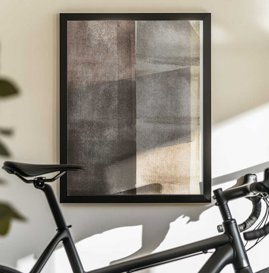 Earth Tones Texture Shapes by Alexandra Weise, black-framed artwork above a bicycle; weathered-looking rectangular shapes in brown, gray, charcoal and cream.