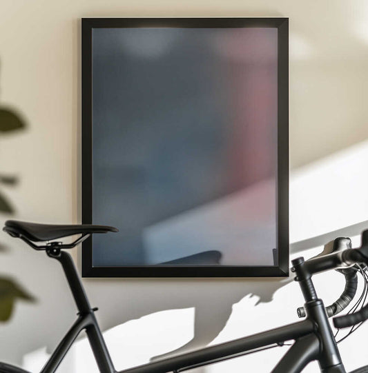 Exquisite Rapture by Mark Russell Jones — black-framed canvas displayed behind a bicycle