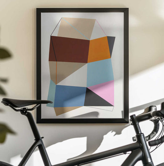 Geo 2.0 (2020) by Ildefonso Martín, black-framed artwork above a bicycle; an angular stack of red, orange, blue, cyan, pink and black geometric planes.