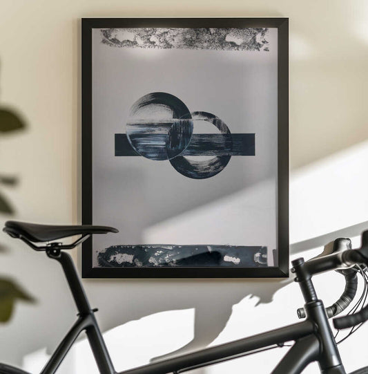Geometria Y Texturas 3 by David Galan, black-framed artwork above a bicycle; overlapping black-and-white brushed circles crossed by a dark horizontal band.