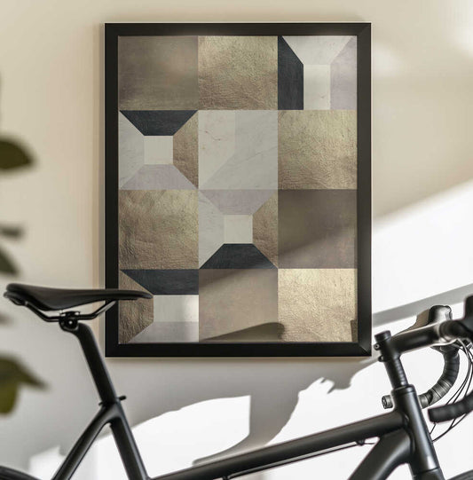 Geometric Gold Rhythm by Vitor Costa, black-framed artwork above a bicycle; gold-toned, gray and black geometric planes arranged in a layered vertical pattern.