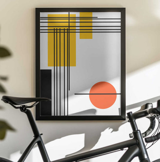 Geometric Shapes by Nicholas, black-framed artwork above a bicycle; fine black intersecting lines with yellow rectangles and an orange circle on white.