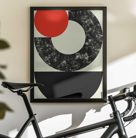 Geometric Shapes with a Bold Red Circle by Petr Strnad, black-framed artwork above a bicycle; a red circle overlapping a distressed black ring above a solid black semicircle.