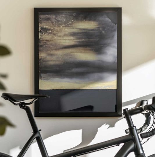 Gold Noir by Alyson Storms — black-framed canvas displayed behind a bicycle