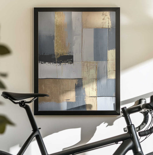 Golden Greys 1 by Sally Ann Moss, black-framed artwork above a bicycle; a tall gold-toned band amid gray and cream rectangles with dark horizontal accents.