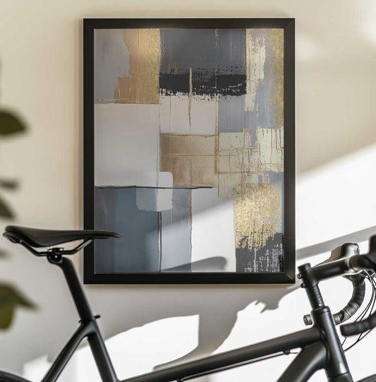 Golden Greys 2 by Sally Ann Moss, black-framed artwork above a bicycle; layered gray, cream and gold-toned rectangles with a dark band near the top.