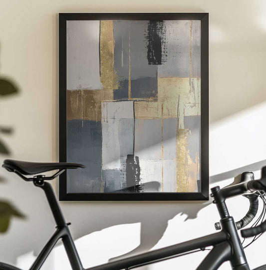 Golden Greys 3 by Sally Ann Moss, black-framed artwork above a bicycle; gray and cream blocks with gold-toned bands and narrow black vertical accents.