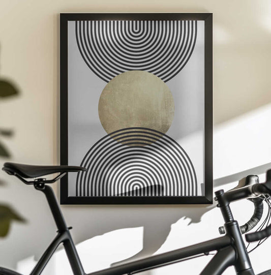 Golden Textured Circle and Bold Black Lines by Vitor Costa, black-framed artwork above a bicycle; a gold-toned central circle between large nested black circular line patterns.