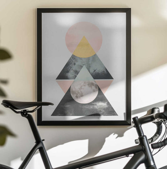 Harmony In Balance by SHANDU, black-framed artwork above a bicycle; stacked triangles and circles in pale pink, yellow, sage and charcoal.