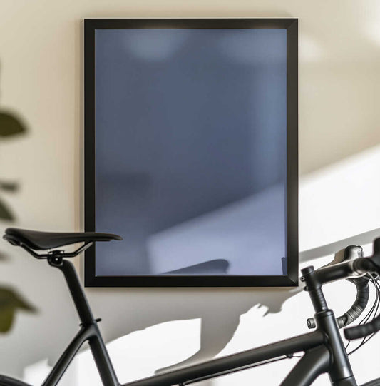 Never Stirred From Here by Mark Russell Jones — black-framed canvas displayed behind a bicycle