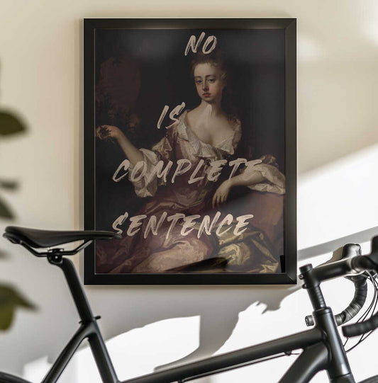 No Is Complete Sentence by The Art Concept — black-framed canvas displayed behind a bicycle
