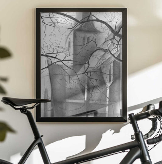 Rijswijk - 04-12-15 by Corné Akkers, in a black frame above a bicycle; a monochrome tower and buildings seen through bare tree branches.