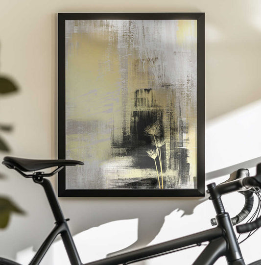 royal gold-3 by Sally Ann Moss, black-framed artwork above a bicycle; pale yellow abstract layers with dark blocks and slender stems.