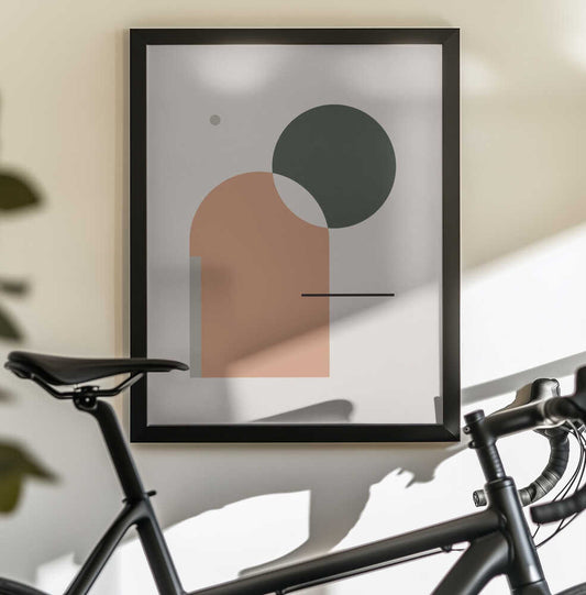 Simple Harmony - Abstract Composition by Nilesh Kulkarni, black-framed artwork above a bicycle; a peach arch overlapped by a dark green circle with a fine black line.