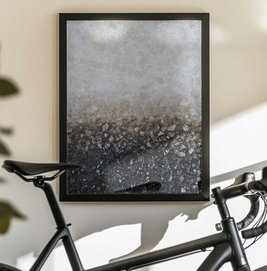 Smoky Crystal by Alyson Storms — black-framed canvas displayed behind a bicycle