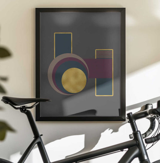 Squares and Circles 3 Grey Bg by Bilge Paksoylu, black-framed artwork above a bicycle; overlapping circles and gold-toned rectangles on dark gray.