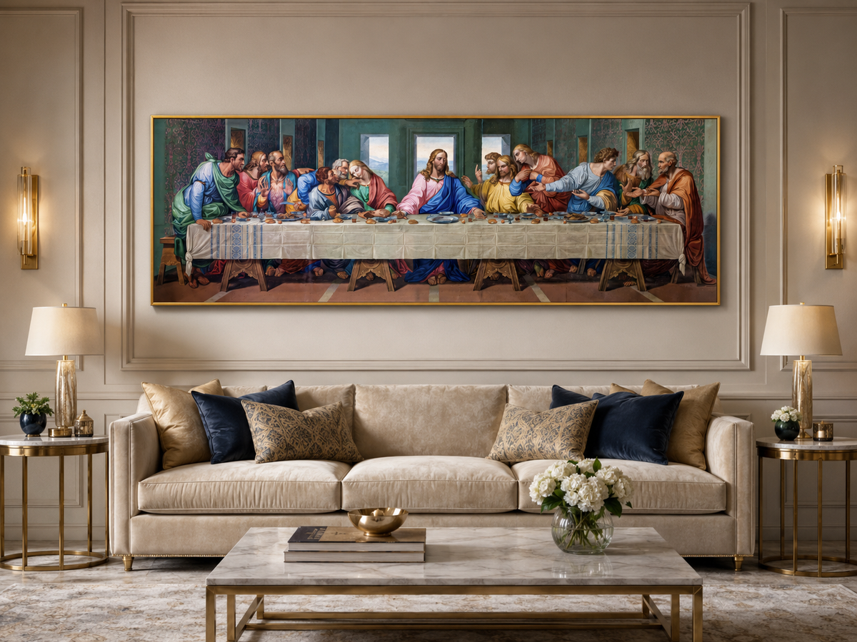 A large framed canvas print of Leonardo da Vinci's Last Supper hangs on a beige wall above a modern beige sofa in a styled living room.