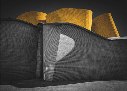 The Museum by Roland M Schwerdtfeger, front view of the artwork; curved gray museum walls beneath yellow architectural forms.