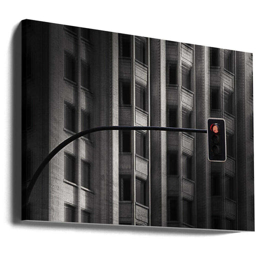 Traffic Light II by Wim Schuurmans, gallery-wrapped canvas viewed at an angle; a red traffic signal against a dark building facade with repeated vertical windows.