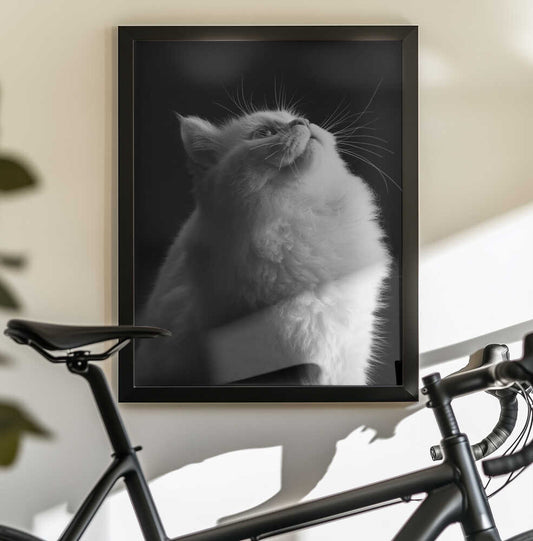 White in Black by Asep Awaludin — black-framed canvas displayed behind a bicycle